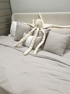 an octopus stuffed animal sitting on top of a bed