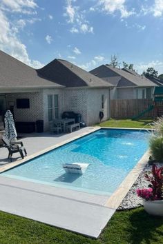 a backyard with a pool and patio furniture