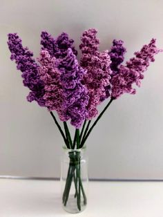 purple flowers in a glass vase on a table