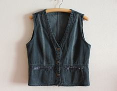 "Women's Vest Denim Vest Womens Denim Vest Fitted Jeans Waistcoat Metal Buttons Womens Country Western Boho Sleeveless Jean Jacket Large Size  Measurements (lying flat): Length: 22\"/ 56 cm Pit to pit: 20 3/4\"/ 52.5 cm Waist: 19\"/ 48 cm Please check measurements to insure a proper fit. Remember to allow yourself some extra room for movement. You can compare these with something from your closet that fits you well. Condition: Great Vintage Condition Material: 100%cotton N.B. Color may slightly differ from picture SHIPPING * I ship worldwide via Priority mail  * Items are shipped 1 - 3 business days after receiving the payment. * I ship from Europe, so please allow 2 to 4 weeks for the package to arrive if you live overseas. * Europe 5 - 10 business days. J 729" Denim Blue Vest For Workwear, Spring Season, Spring Utility Denim Sleeveless Vest, Denim Blue Vest For Workwear In Spring, Spring Utility Sleeveless Denim Vest, Denim Blue Vest For Spring Workwear, Spring Workwear Denim Blue Vest, Summer Utility Style Sleeveless Denim Vest, Dark Wash Sleeveless Denim Top For Work, Spring Sleeveless Utility Denim Vest