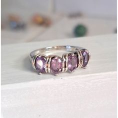 This Is A Beautiful Vintage Oval Cut 4 Stone Brazilian Amethyst Ring. The Design Almost Makes The Gemstones Look As Though They Have Been Wrapped In Silver Wire. It’s A Very Eye-Catching Piece. Amethyst Is The Birthstone For February And The Stone That Celebrates The 6th Anniversary Of Marriage. Vintage Mint Condition W/Tags Gemstone: Brazilian Amethyst Number Of Gemstones: 4 Gem Weight: 3 Carats T.W. Gem Cut: Oval Setting: Prong Metal: 925 Sterling Silver Band Width: 2.5mm Ring Weight: Hallmark Silver Three-stone Gemstones For Anniversary, Silver Three Stone Gemstones For Anniversary, Silver Stackable Gemstones For Anniversary, Silver Stackable Amethyst Ring For Anniversary, Silver Birthstone Gemstones, Silver Amethyst Stackable Jewelry, Silver Stackable Amethyst Jewelry, 4 Stone Ring, Oval Setting