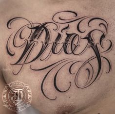 a man's chest with the word bride tattooed on his chest and lettering in black ink