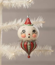 a christmas ornament hanging from a white tree