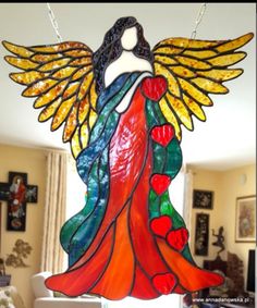 a stained glass angel hanging in a living room