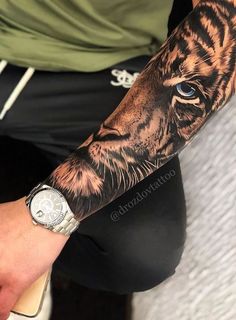 a man with a tiger tattoo on his arm