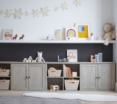 a child's playroom with toys and bookshelves on the shelves in front of it