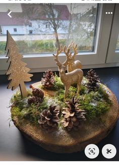 an image of a deer and pine cones on a tree stump in front of a window