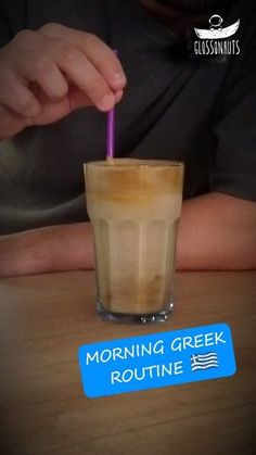 a person holding a purple straw in front of a cup with liquid on it and the words morning greek routine