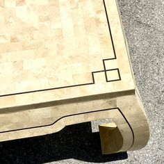 an aerial view of a marble table with a square design on the top and bottom