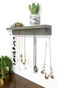 a wall mounted jewelry rack with multiple necklaces