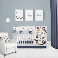 a baby's room with blue walls, white furniture and pictures on the wall