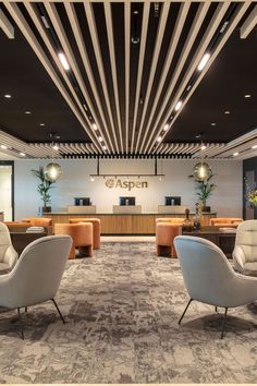 an office lobby with chairs and desks