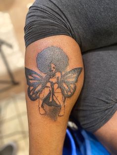 a woman with a butterfly tattoo on her arm