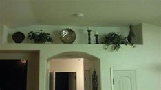 there are many plants on the wall above the door and in the entry way to the house