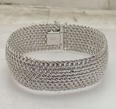 Wide Diamond Cut Mesh Woven Chain Bracelet Anti-tarnish Real Sterling Silver   Metal Product ID Condition Finish Weight Width Size Clasp Retail Price Real Sterling Silver (Stamped 925) RS2-OFI89797 Brand New Polished, Diamond Cut 36.4 grams 22.00mm ~ 7/8"  8 1/2" Box  Clasp $295 An elegant great detailed sterling silver bracelet. Offering timeless elegance, our handcrafted  mesh woven-link bracelet is the kind of piece that always feels completely right. Gorgeous woven links, brightly polished  finish, the perfect width and weight. Includes a rhodium finish to prevent tarnishing. 22mm wide. real solid sterling silver link bracelet. Anniversary Silver Chain Bracelet With Solid Link, Silver Box Chain Bracelet For Anniversary, Silver Chain Bracelet For Anniversary, Kissy Lips, Silver Link Bracelet, Woven Chain, Box Clasp, Fine Jewelry Bracelets, Sterling Silver Bracelet