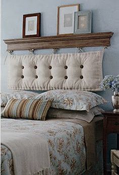 a bedroom with blue walls and white bedding, two framed pictures on the wall