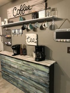 a coffee shop counter with various items on the wall and shelves above it that are made out of wood planks