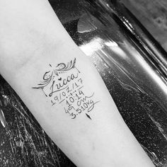 a black and white photo of a person's arm with writing on it