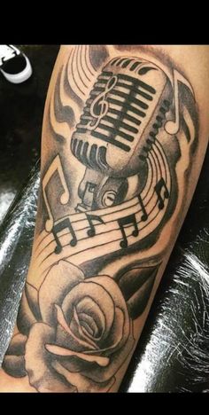 a black and white photo of a microphone with music notes on it's arm