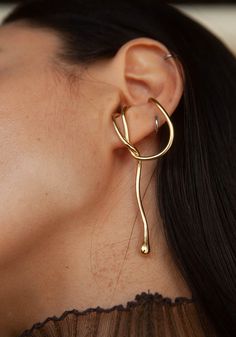 Materials: Brass Drop Length: 2.75" Origin: Los Angeles See More: Shop the entire collection Adjustable Ear Cuff For Formal Occasions, Adjustable Formal Ear Cuff, Unique Metal Ear Cuff, Elegant Handmade Brass Ear Cuff, Gold Pierced Brass Ear Cuff, Elegant Brass Ear Cuff, Adjustable Gold Brass Ear Cuff, Luxury Brass Linear Earrings, Layered Jewelry