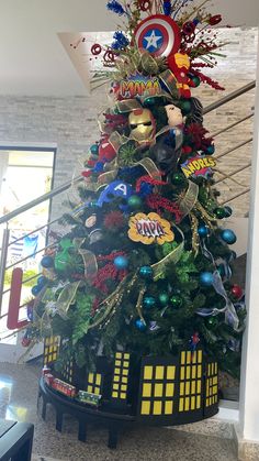 a decorated christmas tree in the shape of a doctor who's house is on display