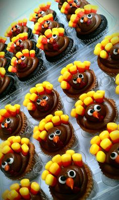 cupcakes with chocolate frosting decorated like turkeys and candy cornucops