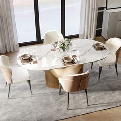 a dining room table with white chairs around it