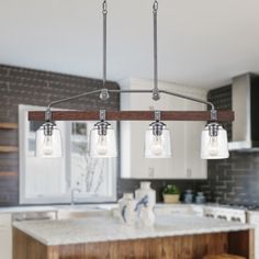 a kitchen island with three lights hanging over it