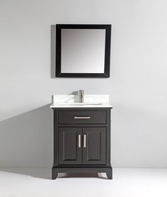 a bathroom vanity with a mirror above it and a black cabinet under the sink,