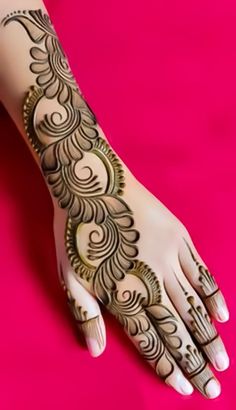 a woman's hand with henna tattoos on it