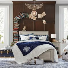 a bed room with a neatly made bed next to a book shelf filled with books