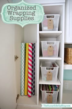 an open closet with several bins on the shelves