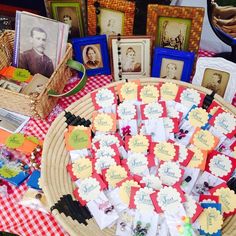 a table topped with lots of cards and pictures next to baskets filled with framed photos