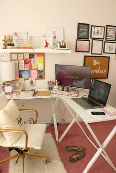 a desk with a laptop computer sitting on top of it next to a white chair