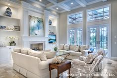 a living room with couches, chairs and a fire place in the middle of it