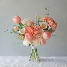 a vase filled with lots of pink and white flowers