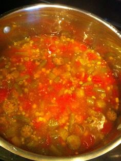 a pot filled with soup sitting on top of a stove