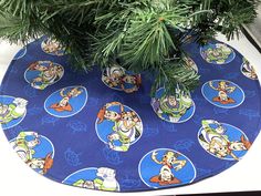 a christmas tree skirt with cartoon characters on it