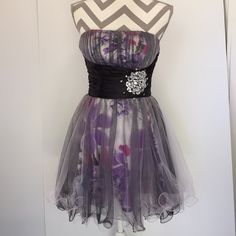 This Dress Has A Flower Print Fabric With Tulle Overlay. The Hem Is Made With Curly Wire Strapless With Gatherer Bodice . Solid Black Waistband With Rhinestones Purple Strapless Mini Dress For Wedding, Purple Strapless Mini Dress For Homecoming, Purple Strapless Formal Mini Dress, Queen Gown, Dancing Queen Dresses, Flower Print Fabric, Gown With Cape, Strapless Homecoming Dresses, Wife Clothes