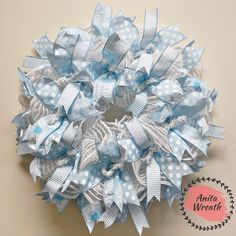 a blue and white wreath with polka dots on the front, attached to a wall