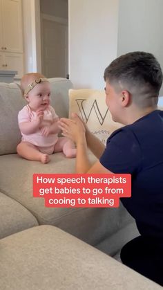 a man sitting on top of a couch next to a baby