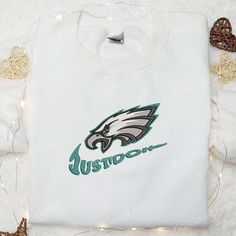 Philadelphia Eagles Just Do It x Nike Swoosh Embroidered Shirt, NFL Sports Embroidered Hoodie, Best Gift Idea Tinicloset, an oasis of sartorial elegance nestled within the bustling streets of Philadelphia, stands as a beacon of style and sophistication in the realm of custom embroidered apparel. With a curated selection of garments ranging from intricately stitched shirts to cozy sweatshirts, T-shirts, and hoodies, each piece exudes a sense of individuality and flair that resonates with fans of White Team Spirit Sweatshirt With Embroidered Graphics, White Sweatshirt With Embroidered Graphics For Team Spirit, White Fleece Sweatshirt With Embroidered Logo, White Crew Hoodie With Embroidered Graphics, White Hoodie With Embroidered Graphics, White Hooded Sweatshirt With Team Logo, White Embroidered Crew Hoodie, White Embroidered Crew Neck Hoodie, White Sweatshirt With Embroidered Sports Graphics