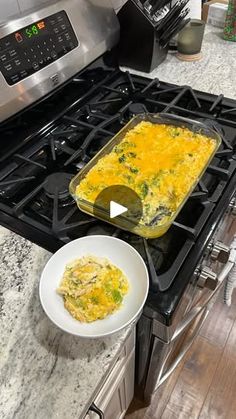 an omelet is being cooked on the stove top with a bowl of food next to it