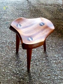 a wooden chair sitting on top of a sidewalk