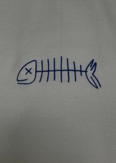 embroidered fishbone on white shirt with blue stitching