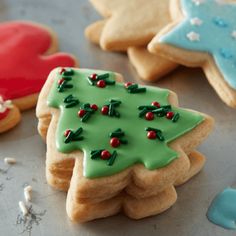 three decorated cookies sitting on top of a table