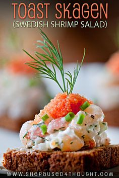 toast skaeen with shrimp and dill on top, served on rye bread