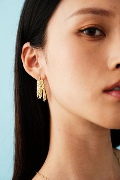 Dive into the bold allure of our 14K Lava Gold Earrings – a mesmerizing dance of recycled gold resembling molten lava. Crafted with meticulous detail, these earrings demand attention and make a sustainable statement. Pair them with a sleek black dress for a night out or elevate your casual jeans-and-tee look for an edgy, chic vibe. Hammered Recycled Gold Earrings, Sleek Black Dress, Molten Lava, Edgy Chic, Recycled Gold, Casual Jeans, Night Dress, Gold Earrings, Night Out