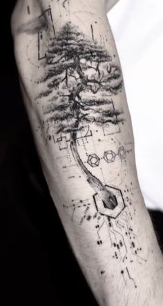 a man's arm with a tree and geometric shapes on the inside of it