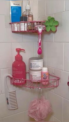 a pink shelf in the corner of a bathroom